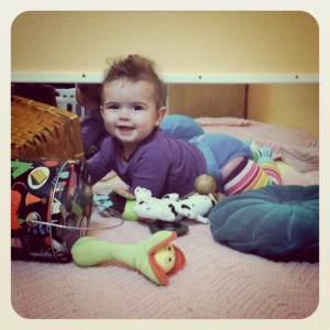phoebe crawling through her toys
